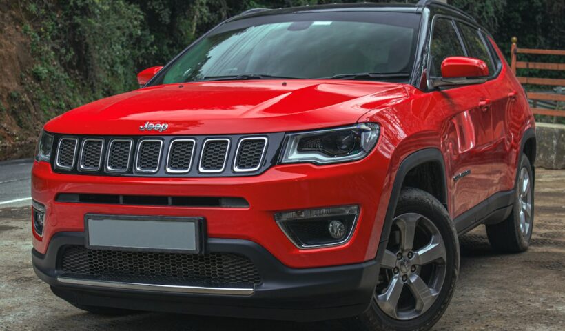 Red SUV on a mountain road illustrating a compact SUV buying guide