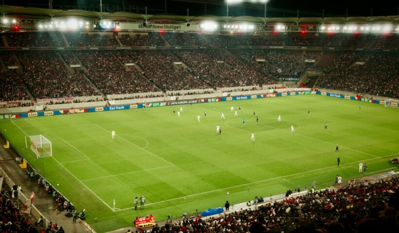 Packed football stadium during a night match