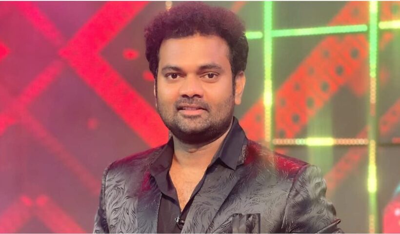 Telugu comedian Auto Ram Prasad in a dark patterned suit