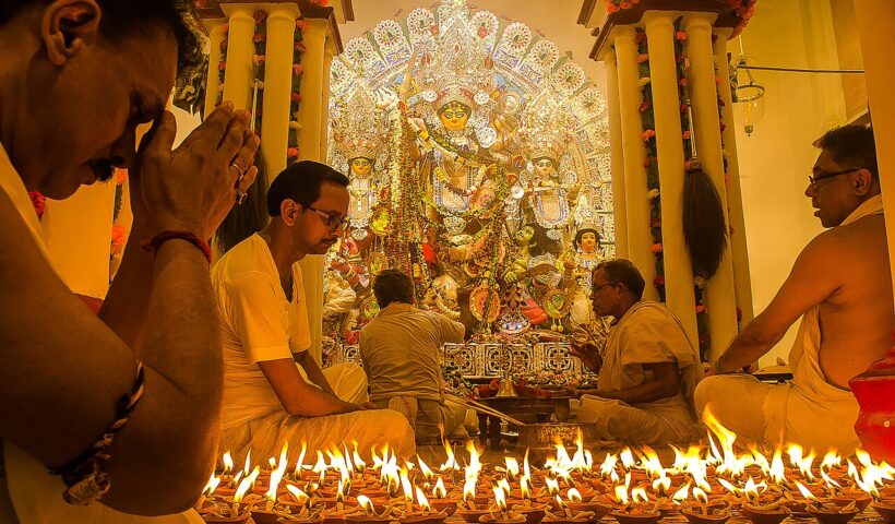 ARCHIVE IMAGE: Durga Puja devotees and lamps at a traditional worship setting; not the 2026 Chorbagan stampede scene.