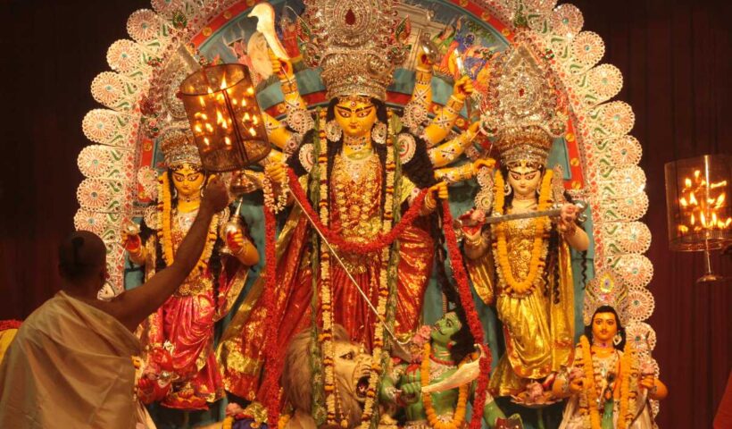 Goddess Durga idol at a decorated Durga Puja pandal.