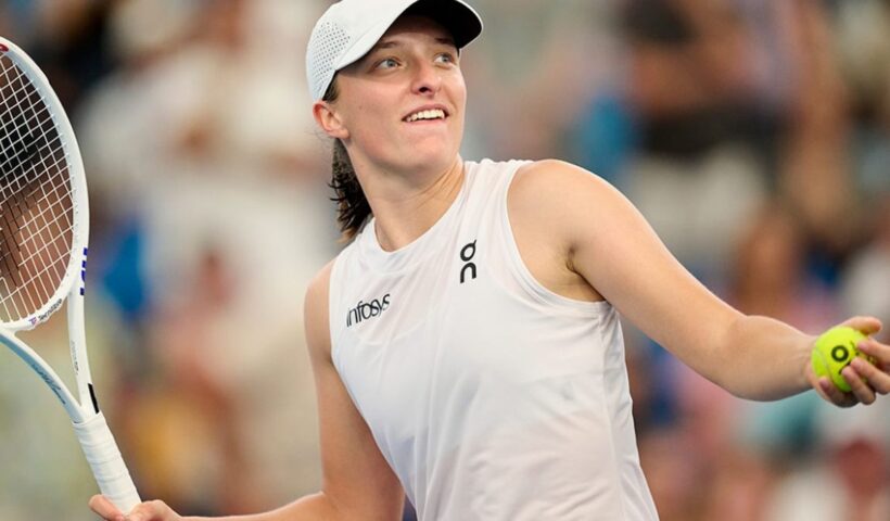 Iga Swiatek on a tennis court during a tournament