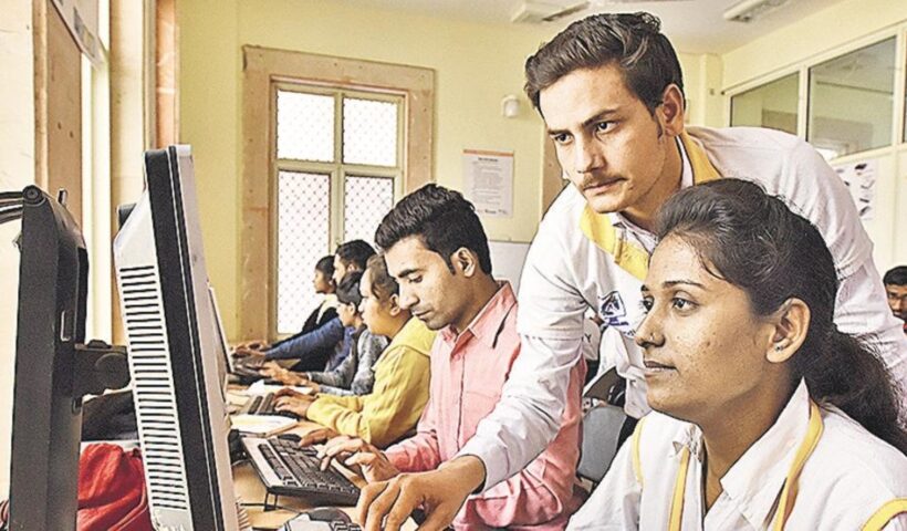 Trainees working at computers during a skills development class in India.