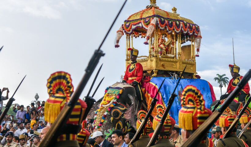 Golden howdah elephant and procession attendants