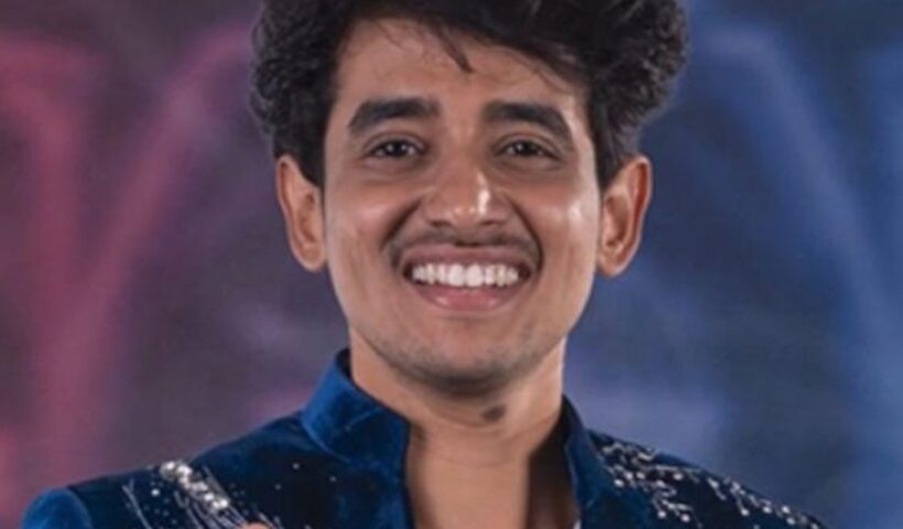 Charan, known as RJ Charan, smiling in a blue sequined jacket for Bigg Boss Telugu 10
